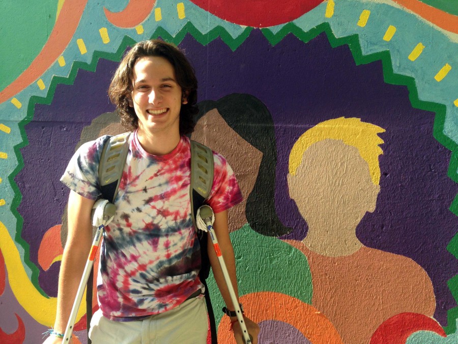 Goff poses in front of one of TLs many student painted murals. 