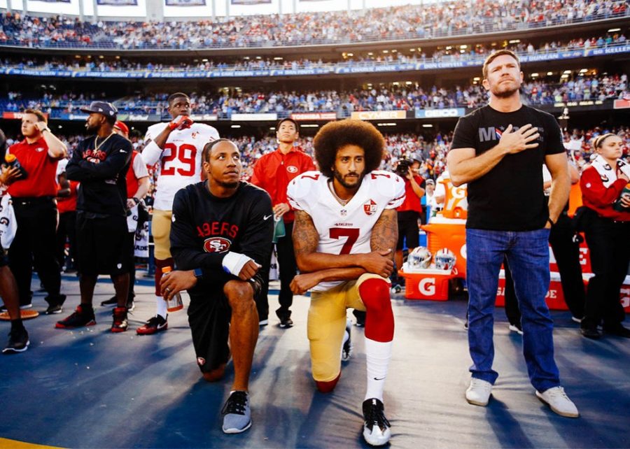 Colin Kaepernick (right) and Eric Reid (left) kneeling during the national anthem before a game. 