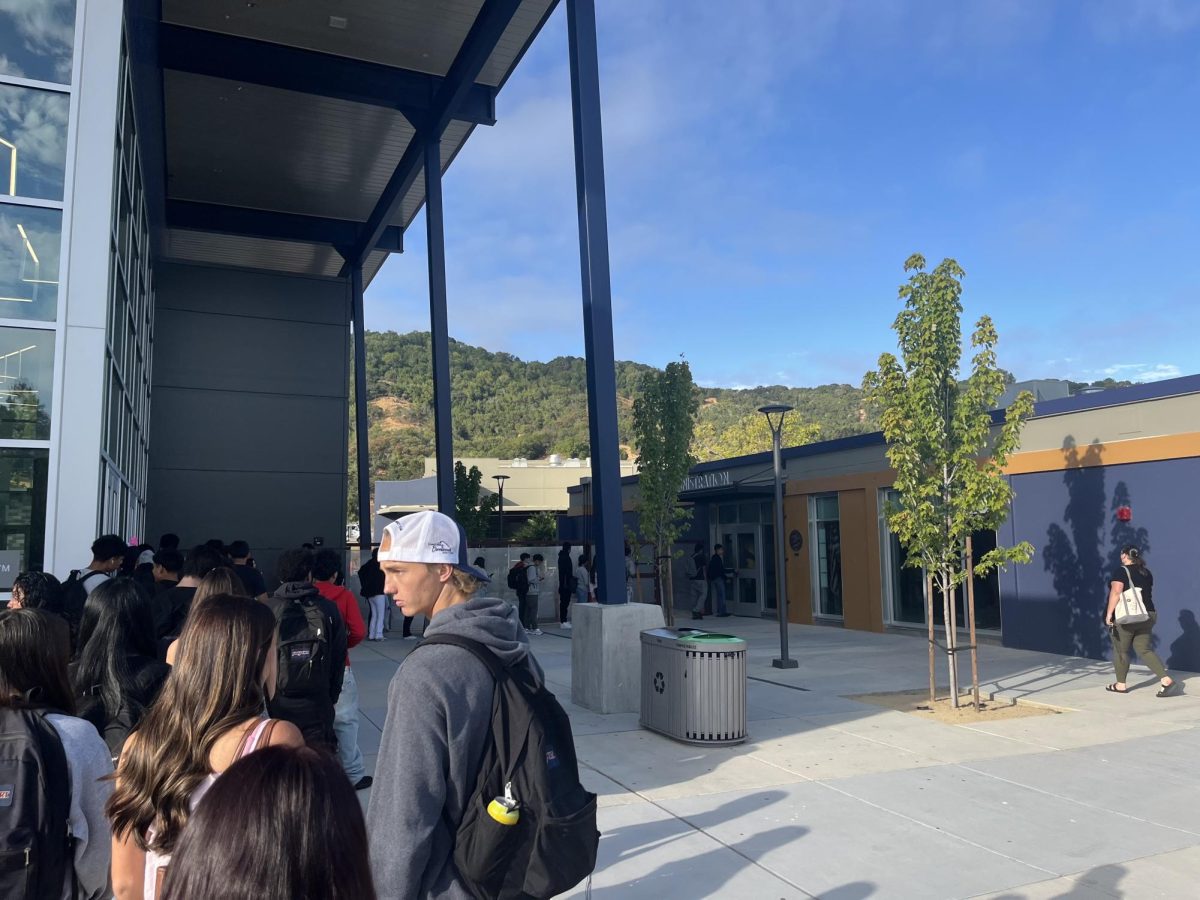 Students wait in line for a tardy pass outside of the office in the morning.
